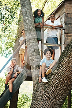 Making summer camp our second home. Shot of a group of teenagers standing next to a treehouse at summer camp.