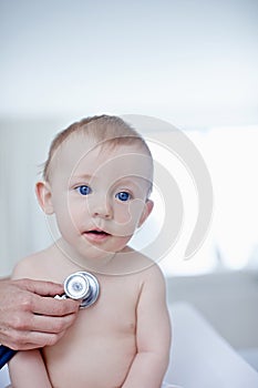 Making sure hes in good health. A baby boy getting examined by a doctor.