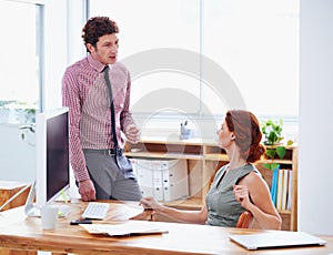 Making sure theyre on the same page. Shot of two businesspeople having a discussion in the office.