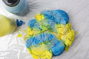 Making a T-shirt with a tie-dye print. blue and yellow color