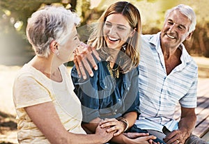 Making time for the people that matter most. a happy young woman spending quality time with her elderly parents outdoors