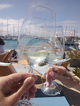 Making a toast with white wine near the Yatchs photo