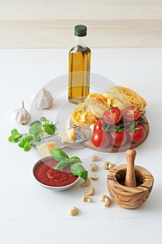 Making tomato pesto, with fresh pasta, parmesan cheese, keshu nuts, basil and olive oil photo