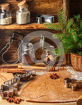 Making traditional gingerbread. Christmas. New year. Raw dough, cutting cookie and condiments on the table