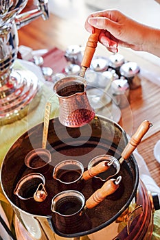 Making of traditional greek / turkish black coffee on sand