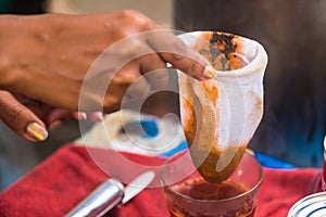 Making traditional Thai milk tea using coffee bag in Stainless Steel Pot. Old Thai tea made shop street food
