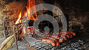 Making traditional Uruguayan grilled sausages, on barbecue photo