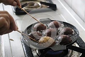 Making of unni appam using unni appam pan. Unni appam or Rice fritters is a traditional snack from the state of Kerala photo