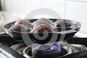 Making of unni appam using unni appam pan. Unni appam or Rice fritters is a traditional snack from the state of Kerala photo