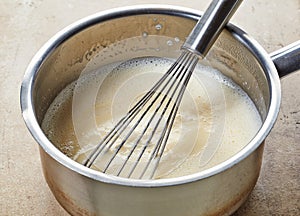 Making vanilla sauce in a pot