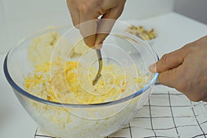 Making vegetarian pizza, mixing ingredients in a bowl.