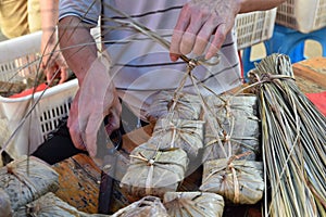 Making zongzi, a traditional Chinese rice dish which is made of glutinous rice