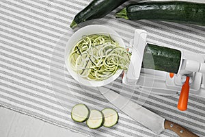 Making zucchini noodles with spiral slicer on table