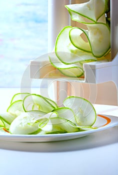 Making zucchini noodles using spiralizer.