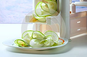 Making zucchini noodles using spiralizer.