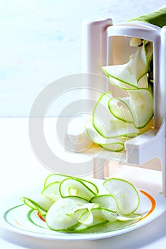 Making zucchini noodles using spiralizer.