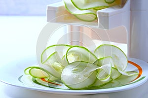 Making zucchini noodles using spiralizer.