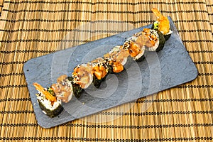 Makis of rice and seaweed with prawns and sesame seeds photo