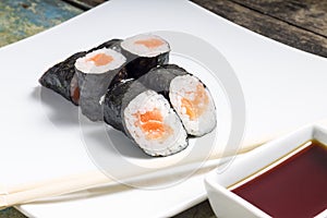 Makisushi on a plate. Seafood traditional maki sushi rolls with chopsticks