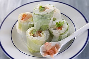 Makizushi. Delicious sushi rolls on white plate with chopsticks