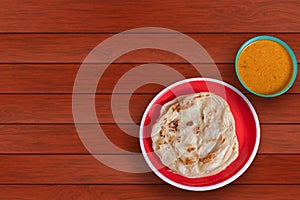 Malabar parotta with chicken curry on a plate