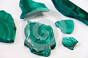 Malachite polished stones on a white background. Copy, empty space for text