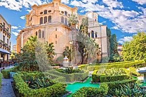 Malaga cathedral and green park colorful street view photo