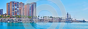 Malaga Port panorama with high rises and lighthouse, Spain photo