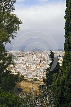 Malaga, Spain, February 2019. Panorama of the Spanish city of Malaga. Buildings, port, bay, ships and mountains against a cloudy s