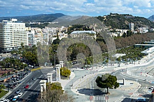 Beautiful view of the historical part of the city of Malaga with a review wheel. Castle, streets, harbor, cars