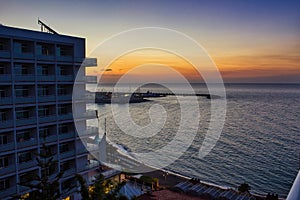 Malaga, Spain - September 02, 2015: Dramatic sunset view of city architecture before beach seashore located in Costa del Sol photo