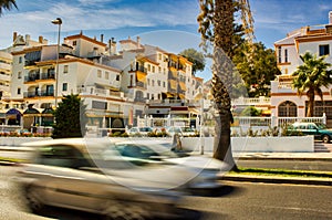 Malaga, Spain - September 01, 2015: Motion blurred traffic in the busy city on a sunny summer time located in Costa del Sol photo