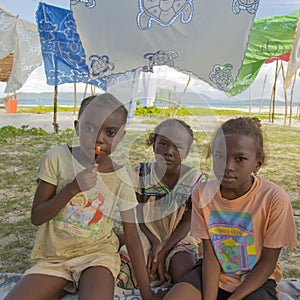 Malagasy girls serious on tropical landscape