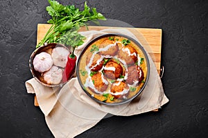 Malai Kofta Curry in black bowl at dark slate background. Malai Kofta is indian cuisine dish Indian Food