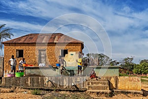 MALANJE/ANGOLA - 10 MAR 2018 - African women and children washing clothes at a water source in rural Africa, Angola. Malanje.