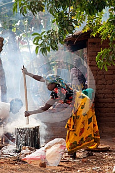 Malawian Woman Cooking Nsima Over Fire