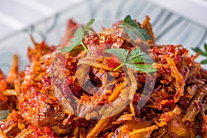 Malay dish stir fried chili with deep fried anchovies and potato cubes