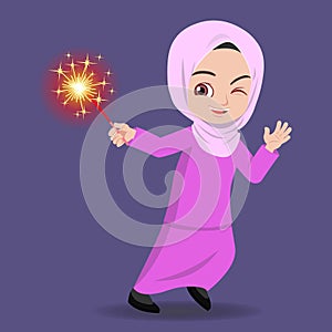 Malay girl happy playing firework in the hari raya aidilfitri photo