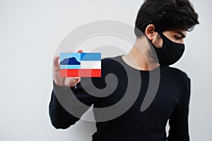 Malay man wear all black with face mask hold Sabah flag in hand isolated on white background. States and federal territories of