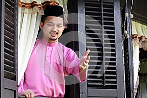 Malay muslim man wavings hand