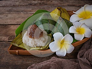 A Malay traditional dessert called Pulut Manis on bamboo dustpan over wooden background.