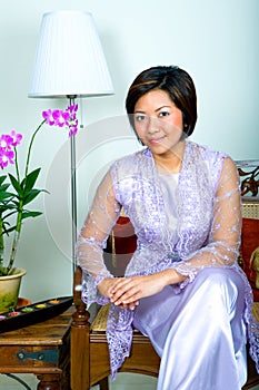 Malay woman in purple lace dress and long skirt