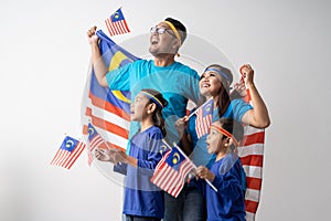 Malaysia family with attributes and flag celebrating