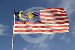 Malaysia flag also known as Jalur Gemilang wave with the blue sky photo
