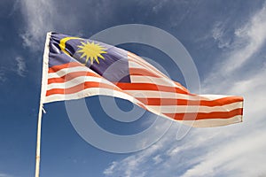 Malaysia flag also known as Jalur Gemilang wave with the blue sky photo