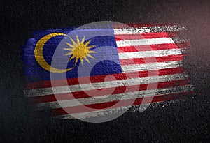 Malaysia Flag Made of Metallic Brush Paint on Grunge Dark Wall