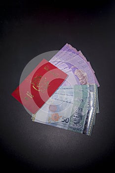 Malaysia money and passport on white background. Close up on Malaysia fifty ringgit money selective focus