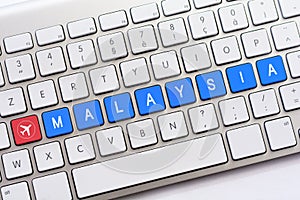 MALAYSIA writing on white keyboard with a aircraft sketch