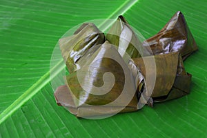 Malaysian delicacies Kuih Koci wrapped in banana leaf.