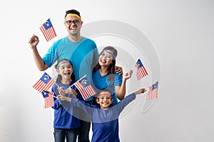 Malaysian family holding malaysia flag over white background